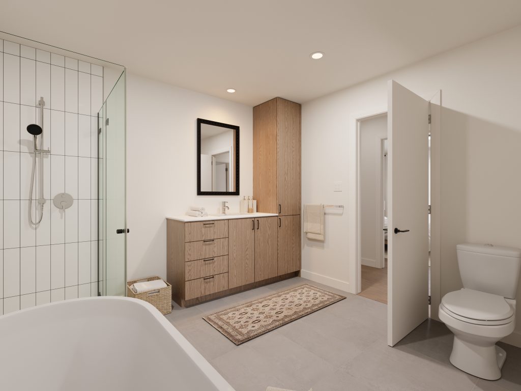 Salle de bain moderne avec bain autoportant et douche vitrée dans un condo neuf - Gestion Floria