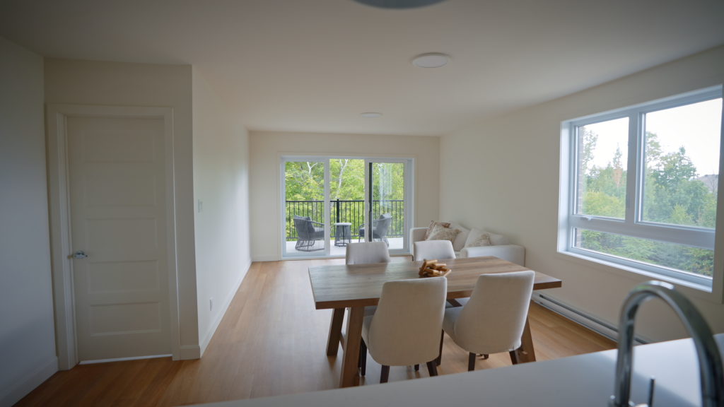 Aperçu de l'aire ouverte d'un condo neuf à louer à Sherbrooke | Cuisine moderne avec îlot et salle à manger lumineuse - Gestion Floria